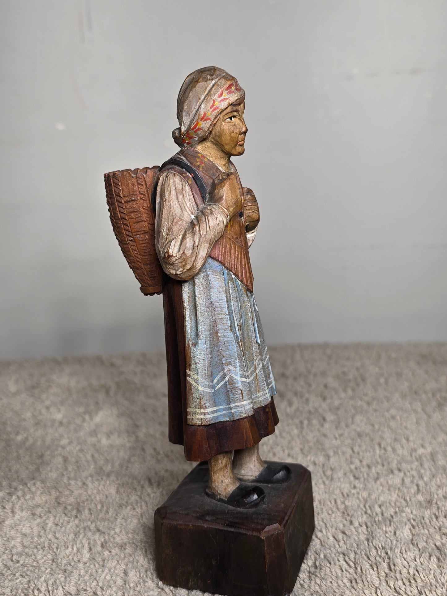 Vintage folk art wood carving of a woman